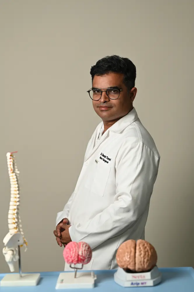 Doctor with spine and brain models at Pluto Hospital, Himatnagar
