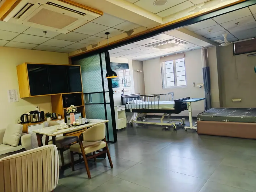 Dining area and patient bed in the VIP suite at Pluto Hospital, Himatnagar