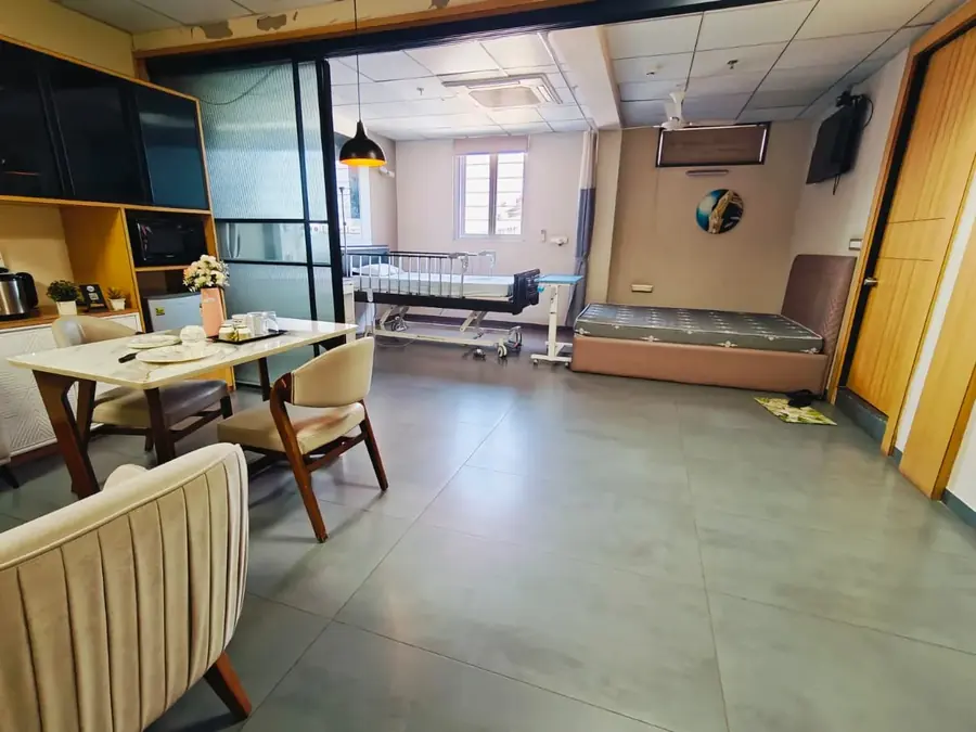 Dining table and attendant bed in the VIP suite at Pluto Hospital